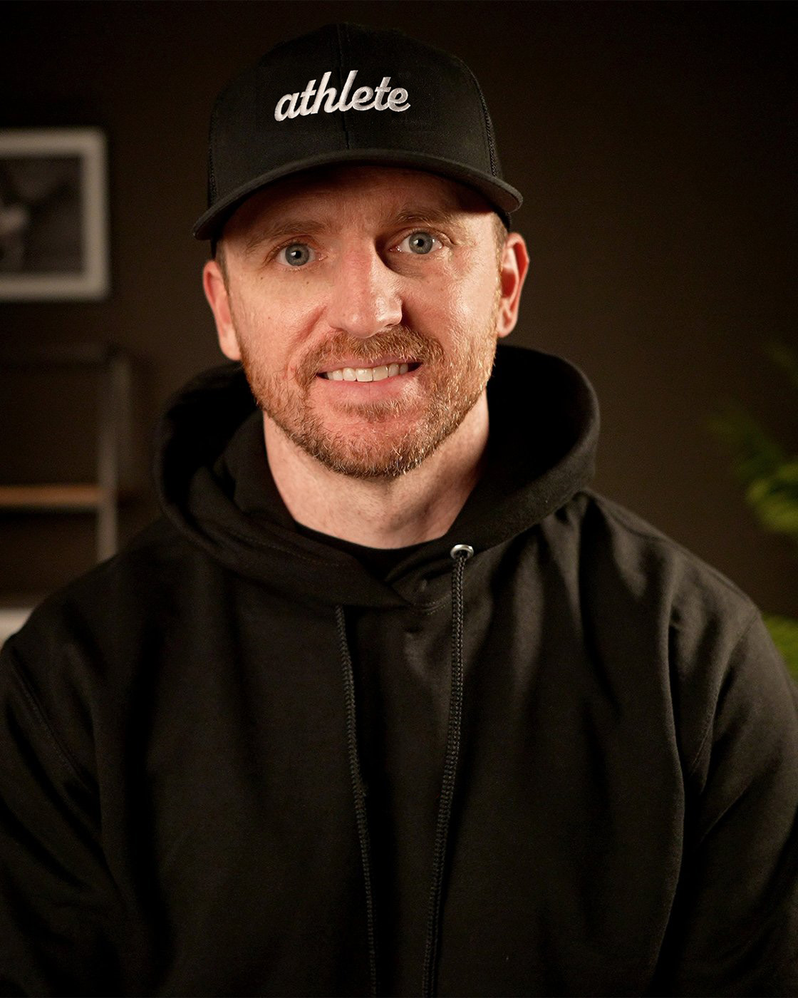 Jerred Moon, writer and founder of Garage Gym Athlete, in an athlete cap and black hoodie.